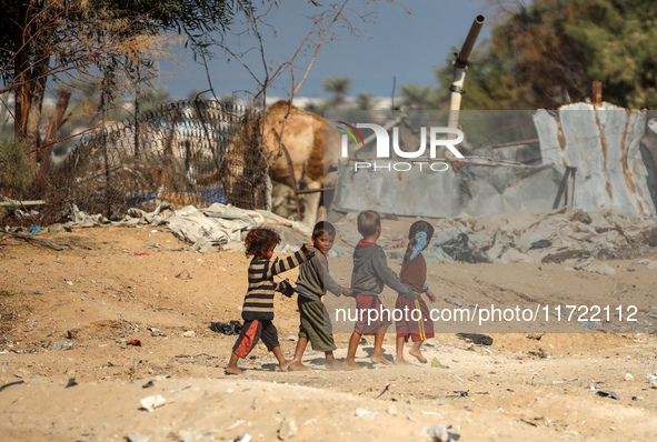 Palestinian Bedouin children play outside their tents in Khan Yunis, southern Gaza Strip, on October 30, 2024, amid the ongoing conflict bet...