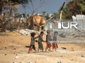 Palestinian Bedouin children play outside their tents in Khan Yunis, southern Gaza Strip, on October 30, 2024, amid the ongoing conflict bet...