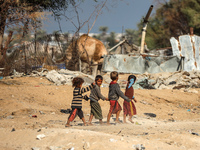 Palestinian Bedouin children play outside their tents in Khan Yunis, southern Gaza Strip, on October 30, 2024, amid the ongoing conflict bet...