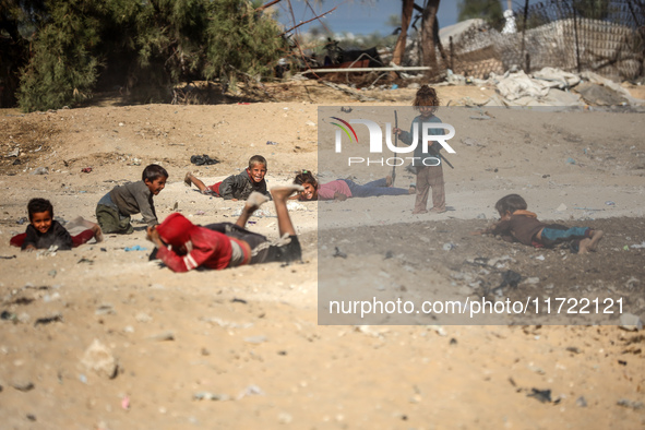 Palestinian Bedouin children play outside their tents in Khan Yunis, southern Gaza Strip, on October 30, 2024, amid the ongoing conflict bet...