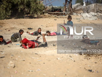 Palestinian Bedouin children play outside their tents in Khan Yunis, southern Gaza Strip, on October 30, 2024, amid the ongoing conflict bet...