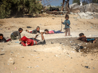 Palestinian Bedouin children play outside their tents in Khan Yunis, southern Gaza Strip, on October 30, 2024, amid the ongoing conflict bet...