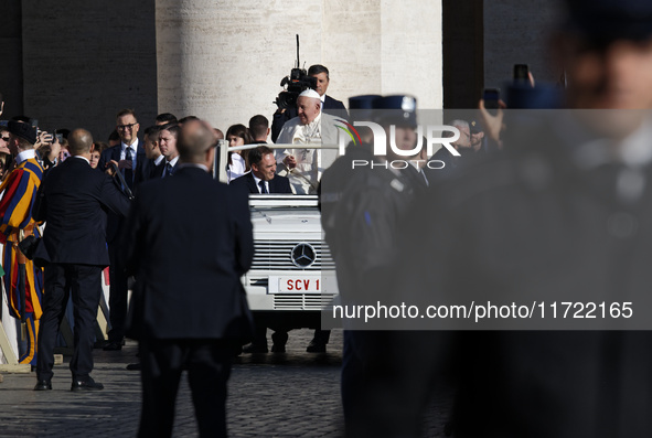 Pope Francis waves to the crowd from the popemobile as he arrives for the weekly general audience at Saint Peter's Square in The Vatican on...