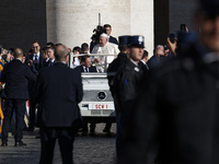 Pope Francis waves to the crowd from the popemobile as he arrives for the weekly general audience at Saint Peter's Square in The Vatican on...