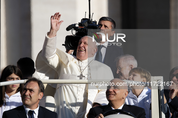 Pope Francis looks up from the popemobile as he arrives for the weekly general audience at Saint Peter's Square in The Vatican on October 30...