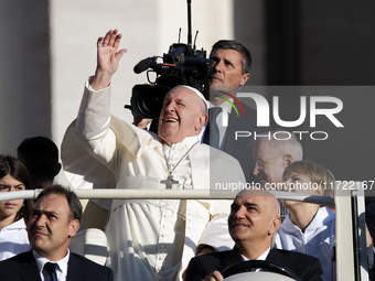 Pope Francis looks up from the popemobile as he arrives for the weekly general audience at Saint Peter's Square in The Vatican on October 30...