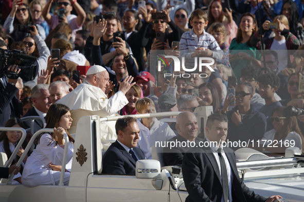 Pope Francis greets the crowd at the end of the weekly general audience at St. Peter's Square in The Vatican on October 30, 2024. 