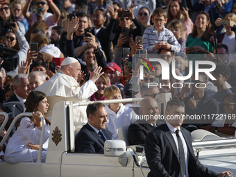 Pope Francis greets the crowd at the end of the weekly general audience at St. Peter's Square in The Vatican on October 30, 2024. (