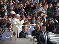 Pope Francis greets the crowd at the end of the weekly general audience at St. Peter's Square in The Vatican on October 30, 2024. (