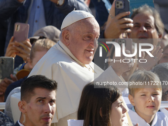 Pope Francis greets the crowd at the end of the weekly general audience at St. Peter's Square in The Vatican on October 30, 2024. (