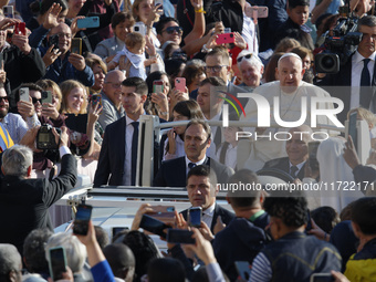 Pope Francis greets the crowd at the end of the weekly general audience at St. Peter's Square in The Vatican on October 30, 2024. (