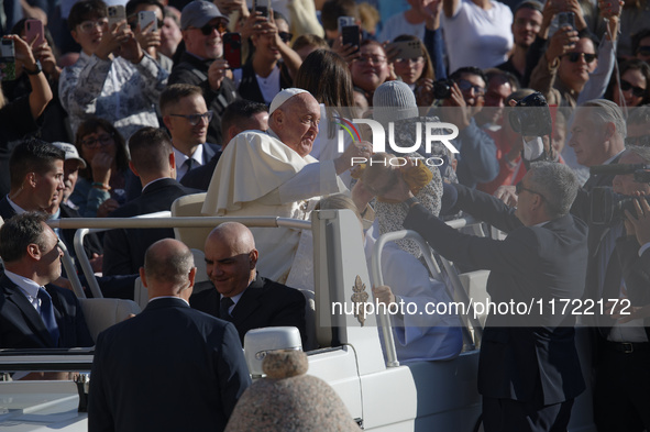 Pope Francis greets the crowd at the end of the weekly general audience at St. Peter's Square in The Vatican on October 30, 2024. 