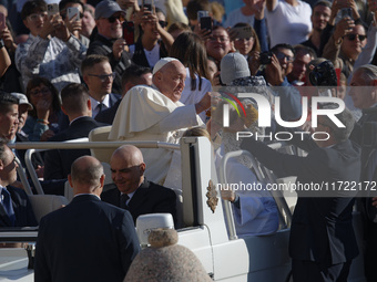 Pope Francis greets the crowd at the end of the weekly general audience at St. Peter's Square in The Vatican on October 30, 2024. (