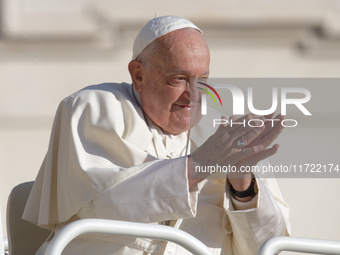 Pope Francis greets the crowd at the end of the weekly general audience at St. Peter's Square in The Vatican on October 30, 2024. (