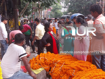 Sellers sell flowers at the roadside as people buy marigold and lotus flowers to decorate their houses during Diwali, the festival of Lights...