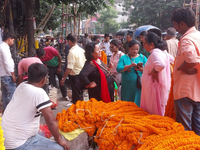 Sellers sell flowers at the roadside as people buy marigold and lotus flowers to decorate their houses during Diwali, the festival of Lights...