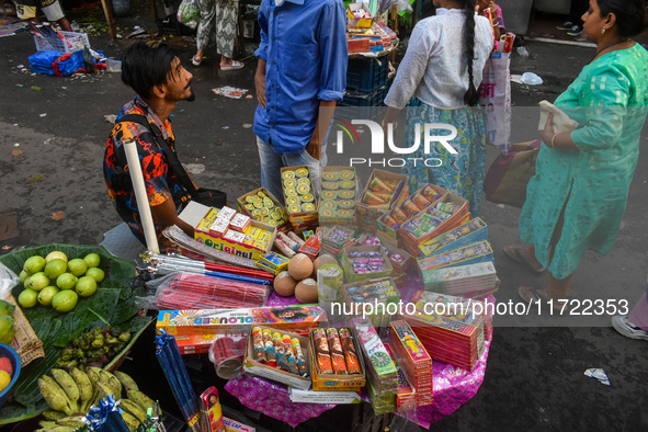 A shopkeeper sells firecrackers at a market ahead of the Diwali festival in Kolkata, India, on October 30, 2024. 