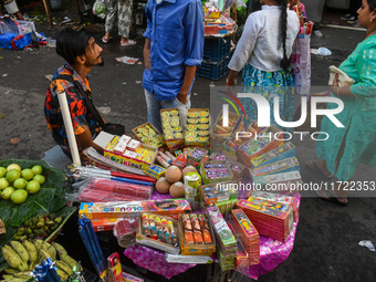 A shopkeeper sells firecrackers at a market ahead of the Diwali festival in Kolkata, India, on October 30, 2024. (