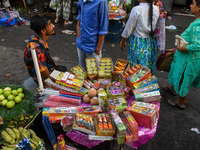 A shopkeeper sells firecrackers at a market ahead of the Diwali festival in Kolkata, India, on October 30, 2024. (