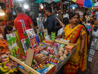 A shopkeeper sells firecrackers at a market ahead of the Diwali festival in Kolkata, India, on October 30, 2024. (