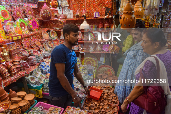 People buy clay lamps at a market ahead of the Diwali festival in Kolkata, India, on October 30, 2024. 