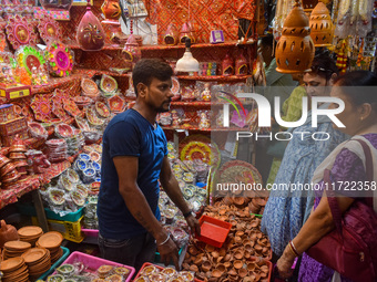 People buy clay lamps at a market ahead of the Diwali festival in Kolkata, India, on October 30, 2024. (