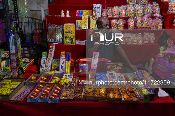 A shopkeeper sells firecrackers at a market ahead of the Diwali festival in Kolkata, India, on October 30, 2024. 