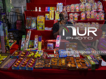 A shopkeeper sells firecrackers at a market ahead of the Diwali festival in Kolkata, India, on October 30, 2024. (