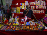 A shopkeeper sells firecrackers at a market ahead of the Diwali festival in Kolkata, India, on October 30, 2024. (