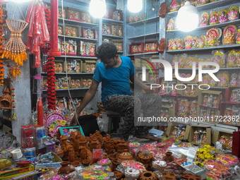 People buy clay lamps at a market ahead of the Diwali festival in Kolkata, India, on October 30, 2024. (