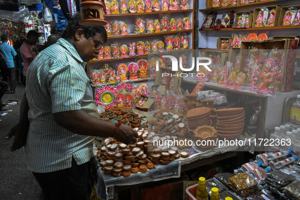 People buy clay lamps at a market ahead of the Diwali festival in Kolkata, India, on October 30, 2024. 