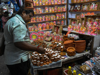 People buy clay lamps at a market ahead of the Diwali festival in Kolkata, India, on October 30, 2024. (