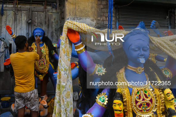 Artisans give final touches to idols of Goddess Kali ahead of the Kali Puja festival celebration in Kolkata, India, on October 30, 2024. 