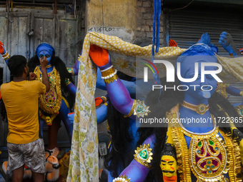 Artisans give final touches to idols of Goddess Kali ahead of the Kali Puja festival celebration in Kolkata, India, on October 30, 2024. (