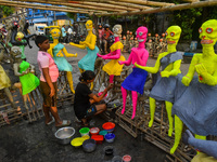 A girl paints figurines of demons that are for sale ahead of Bhoot Chaturdashi, or the Indian Halloween festival, in Kolkata, India, on Octo...