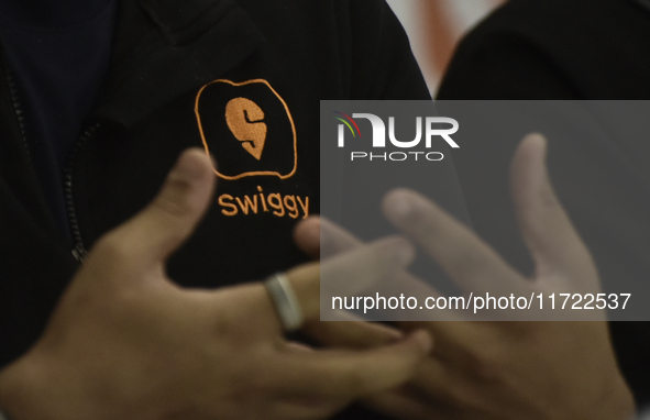 A Swiggy signage appears on a t-shirt during a press conference announcing its forthcoming Initial Public Offering (IPO) in Mumbai, India, o...