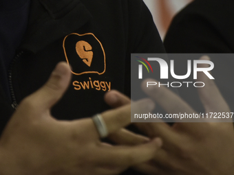 A Swiggy signage appears on a t-shirt during a press conference announcing its forthcoming Initial Public Offering (IPO) in Mumbai, India, o...