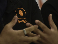 A Swiggy signage appears on a t-shirt during a press conference announcing its forthcoming Initial Public Offering (IPO) in Mumbai, India, o...