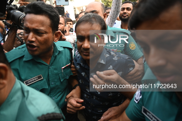 Former police DC Jasim Uddin Mollah is escorted to the International Criminal Tribunal after being arrested in a July murder case of an anti...