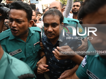 Former police DC Jasim Uddin Mollah is escorted to the International Criminal Tribunal after being arrested in a July murder case of an anti...