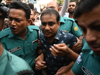 Former police DC Jasim Uddin Mollah is escorted to the International Criminal Tribunal after being arrested in a July murder case of an anti...