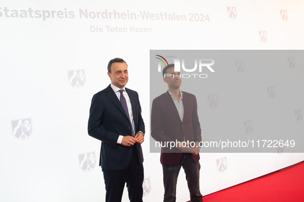 Paul Ziemiak, a member of the German Bundestag, and Tim Achtermeyer, a German politician, pose for pictures on the red carpet of Roncalli's...