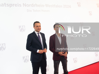 Paul Ziemiak, a member of the German Bundestag, and Tim Achtermeyer, a German politician, pose for pictures on the red carpet of Roncalli's...