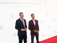 Paul Ziemiak, a member of the German Bundestag, and Tim Achtermeyer, a German politician, pose for pictures on the red carpet of Roncalli's...