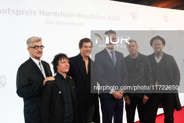 Wim Wenders, a German filmmaker, Stephen George Ritchie, Andreas Frege alias Campino, Andreas Meurer, and Andrea, members of the rock band D...