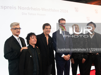 Wim Wenders, a German filmmaker, Stephen George Ritchie, Andreas Frege alias Campino, Andreas Meurer, and Andrea, members of the rock band D...