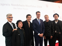 Wim Wenders, a German filmmaker, Stephen George Ritchie, Andreas Frege alias Campino, Andreas Meurer, and Andrea, members of the rock band D...