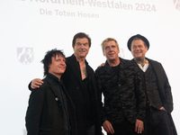 Stephen George Ritchie, Andreas Frege alias Campino, Andreas Meurer, and Andrea, members of the rock band Die Toten Hosen, pose for pictures...