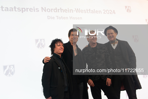 Stephen George Ritchie, Andreas Frege alias Campino, Andreas Meurer, and Andrea, members of the rock band Die Toten Hosen, pose for pictures...