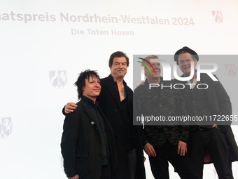 Stephen George Ritchie, Andreas Frege alias Campino, Andreas Meurer, and Andrea, members of the rock band Die Toten Hosen, pose for pictures...